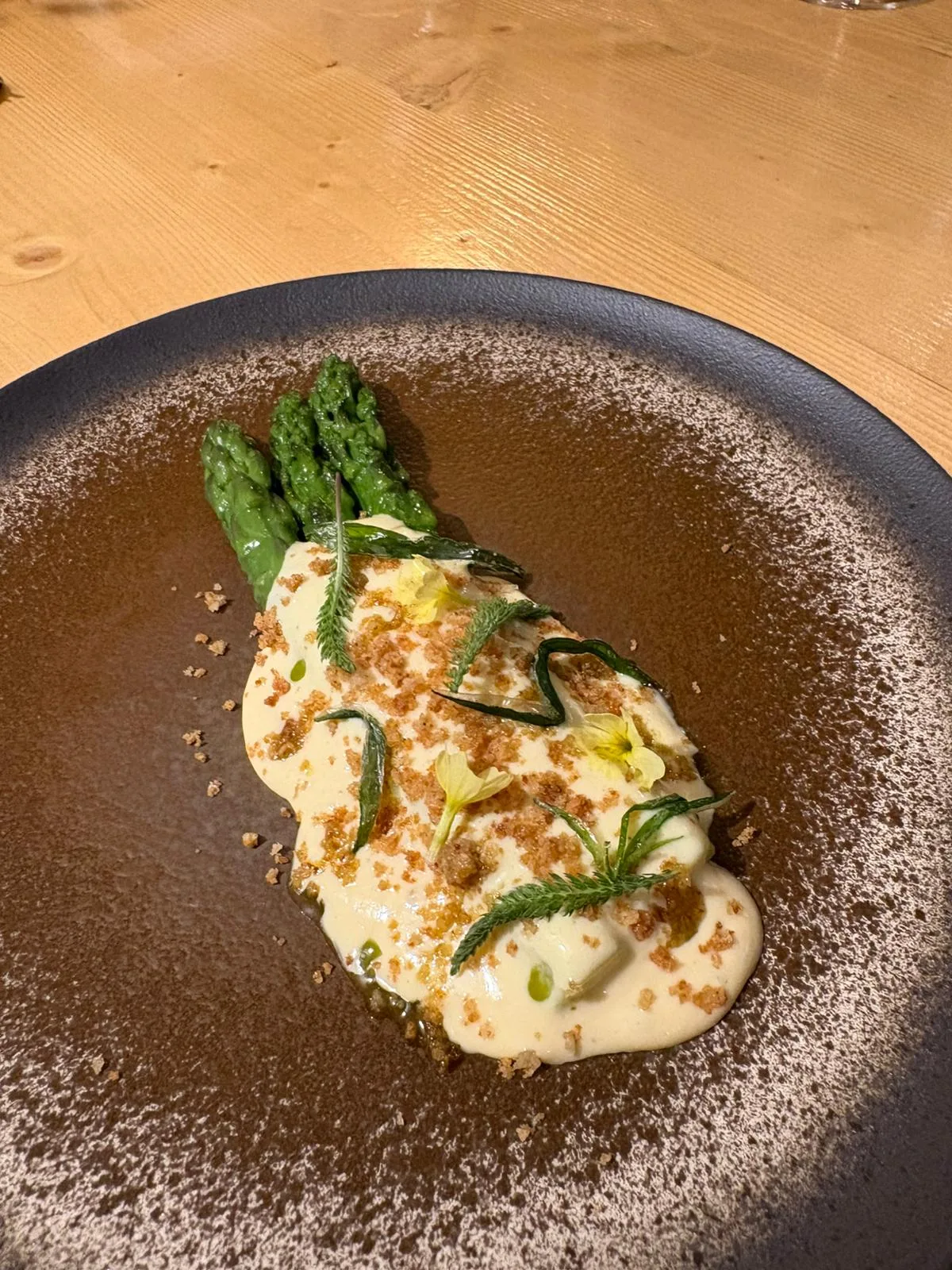 Delicate golden tortellini garnished with fresh herbs in a light broth, illustrating the kitchen's mastery of handcrafted pasta with regional ingredients.