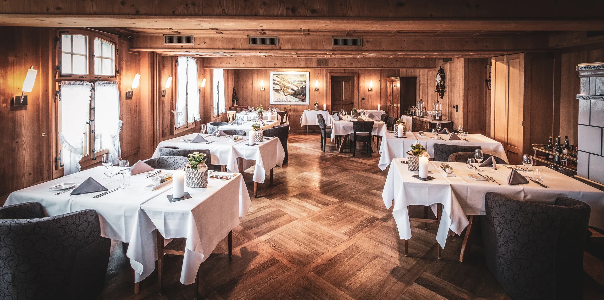 Aerial golden-hour view of Dürrenroth village nestled in misty rolling Emmental hills, perfectly evoking the idyllic Swiss countryside setting of the Romantik Hotel Bären.